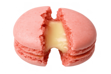 Pink macaron split in half showing creamy filling. Delicious gourmet french cookie with transparent background