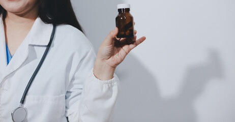The pharmacist or doctor holding medication or medicine for treatment. Anti biotic pill in the vial.