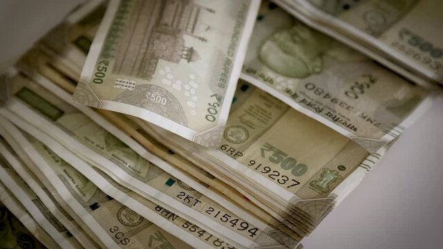 Spreading ₹500 Indian Rupee Banknotes on White Background in Slow Motion