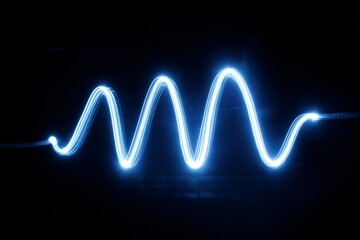 A vivid blue light forms an undulating wave pattern against a black backdrop, illustrating the concept of energy and motion in a striking visual display