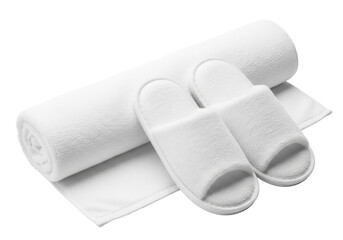 White slippers and rolled towel