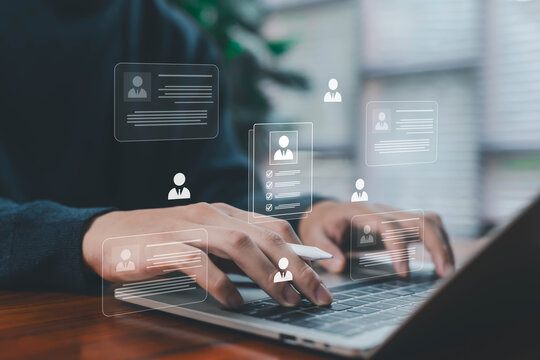 Business person using laptop to manage digital candidate profiles with virtual resumes, recruitment data, and HR analytics interface representing hiring process, talent management, and human resources