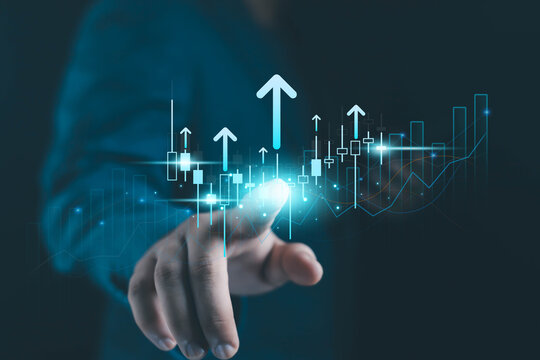 Business hand touching digital financial growth chart with rising arrows, candlestick data, and futuristic analytics interface representing market trends, investment strategy, and economic success.
