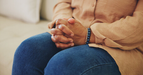 Hands, nervous and thinking with person on sofa in living room of home for anxiety or tension....