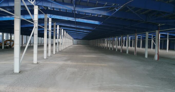Commercial vs. Industrial construction. Steel structure in the industrial factory. Factory building Steel structure. The interior of a industrial building or factory with steel constructions. Indoor