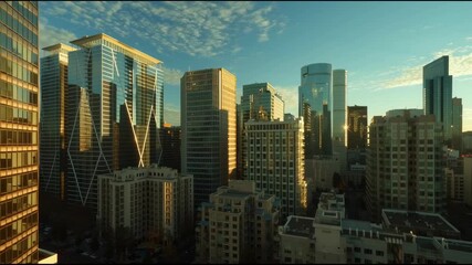 Modern cityscape sunrise with skyscraper glass buildings reflecting light, urban architecture and building growth, ideal for fixed income investment