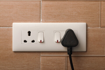 modern switches and 3 Pin Electric Plug on switchboard	
