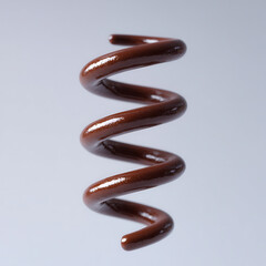 Shiny brown metal coil spring isolated on light background, close up detail showing smooth surface and spiral shape, industrial object with minimalistic style