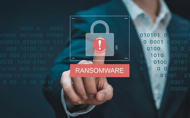 A persons finger is pressing a button with the word ransomware on it, with a padlock icon and an exclamation mark, symbolizing cyber security threat and data protection