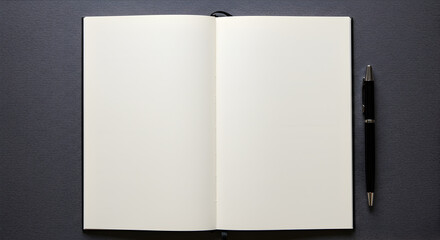 Open notebook with blank pages next to a black pen on a dark textured surface © hendrik