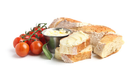 Cut baguette with butter, basil and tomatoes isolated on white