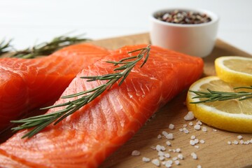 Pieces of salmon fillet, spices and lemon on table, closeup