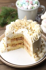 Delicious cake with Christmas decor and marshmallows on wooden table, closeup
