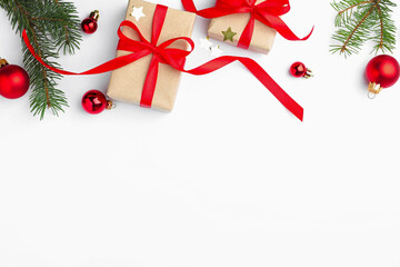 Fir tree branches, gift boxes and Christmas decor on white background, flat lay. Space for text