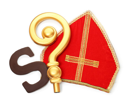 Saint Nicholas (Sinterklaas) day. Red mitre, chocolate letter S and golden crosier isolated on white, top view - Powered by Adobe