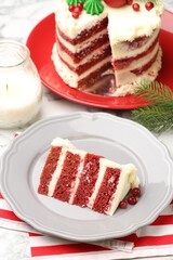 Slice of tasty cake with cranberries served on white table. Christmas dessert