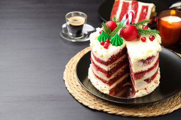 Tasty cake with Christmas decor on black table. Space for text