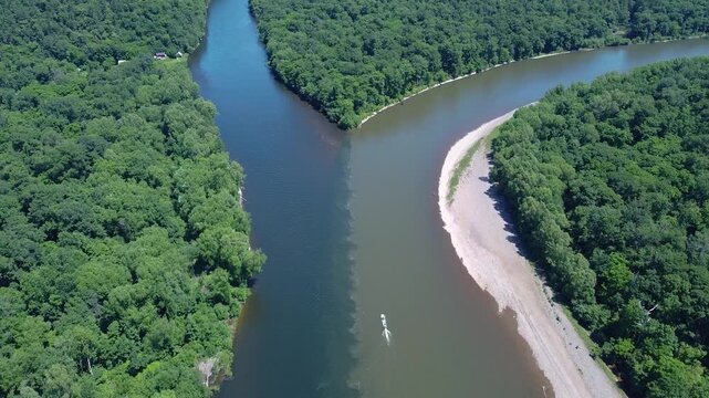 View from above. The confluence of two rivers with clean and dirty water. River pollution. Gold mining. An environmental disaster.
