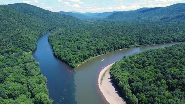 View from above. The confluence of two rivers with clean and dirty water. River pollution. Gold mining. An environmental disaster.