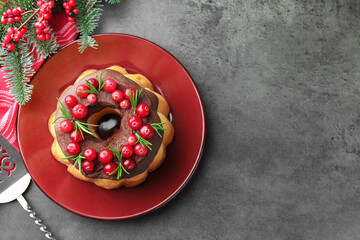 Tasty cake with cranberries, server and Christmas decor on grey table, flat lay. Space for text