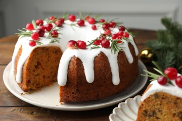 Tasty cake with cranberries and Christmas decor on wooden table, closeup