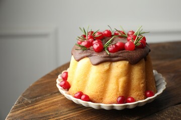 Tasty Christmas cake with cranberries on wooden table, closeup. Space for text
