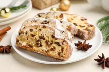 Slices of Stollen (traditional Christmas cake) served on white table, closeup