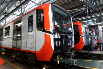Row of cabins of the first car of a modern metro passenger car at the depot on the tracks in the garage at the parking lot and being checked before leaving for the route line