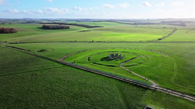 High wide aerial shot of Stonehenge with large numbers of tourists.