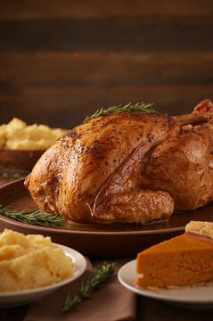 Close-Up of Traditional Thanksgiving Turkey and Side Dishes on Rustic Table	