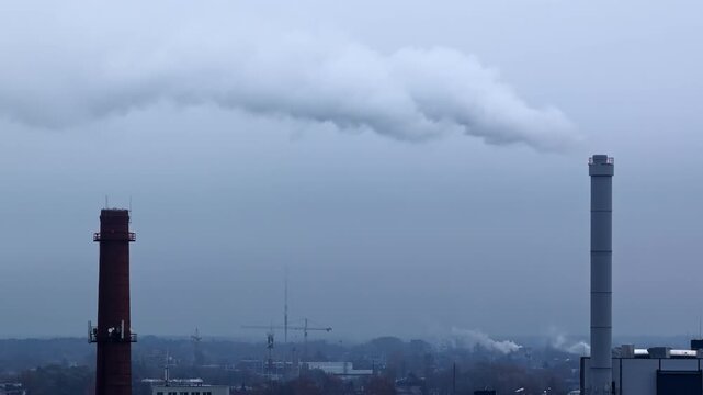 Burning power station emitting steam into the atmosphere on a cloudy day