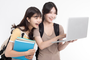 Excited Asian female students watching the laptop