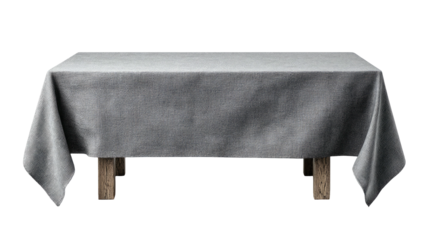 Table with a gray tablecloth, wooden legs, against black background
