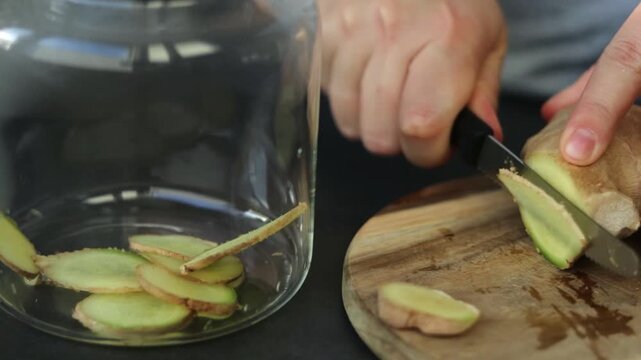 Close up of a female preparing fresh ginger for tea, homemade antioxidant hot drink 