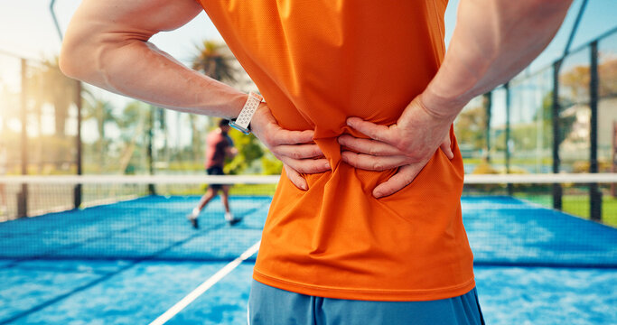 Hands, person and back pain on tennis court from fitness, match accident and muscle sprain. Player, discomfort and joint strain for exercise mistake, inflammation and sports injury of tournament game