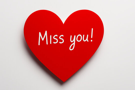 Red paper heart with handwritten Miss you text on white background. Romantic message of longing, love, or emotional connection for card or banner - Powered by Adobe
