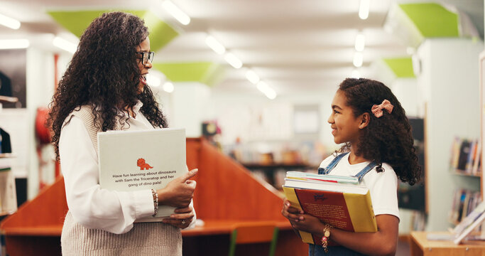 Books, conversation and teacher with child in library for education, learning and support for development. Feedback, talking and woman educator with girl kid for knowledge, discussion or advice. - Powered by Adobe