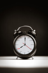 Naklejka premium The hands of clock point to September on dial black alarm clock with copy space. Concept of monthly goal planning, important appointments and effective time management. Vertical