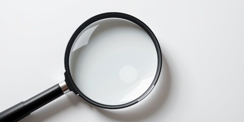 Magnifying glass focusing on a reflective surface, illustrating clarity and detail.