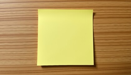 Blank yellow sticky note on a wooden surface.