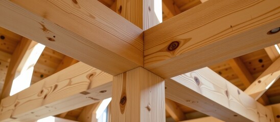 Wooden beams intersecting in a structural design showcasing craftsmanship and natural texture.