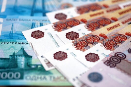 Russian ruble money bills banknotes lies in big pile on table close up. Concept of finances and business in Russian Federation - Powered by Adobe