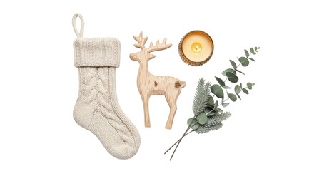 Isolated knitted Christmas stocking, wooden reindeer, candle, and greenery for festive season