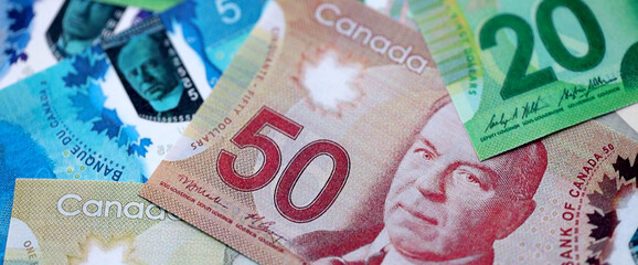 Canadian Dollar currency money bills. CAD currency banknotes in pile with different denomination close up