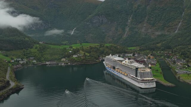 Aerial footage of cruise ship docked in picturesque Flam, nestled in Norway&rsquo;s fjords