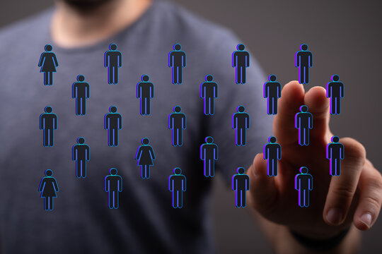Hand pointing at a collection of digital figures representing connectivity, social networking, and community. C