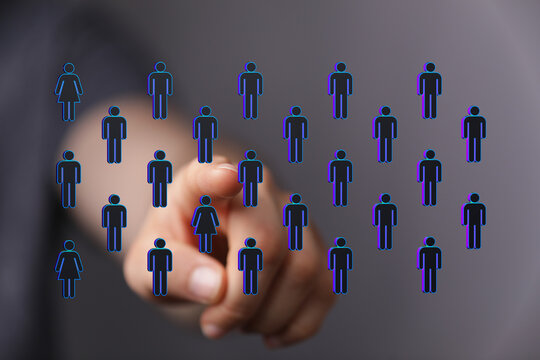 Concept of teamwork, diversity and leadership. Man's finger pointing at human icons, representing people, commu