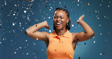 Excited, confetti and black woman in studio, celebration and announcement on blue background....