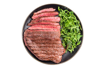 Juicy grilled top sirloin on a plate, accompanied by seasonal greens for a delicious meal. isolated on white background. top view