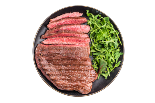 Juicy grilled top sirloin on a plate, accompanied by seasonal greens for a delicious meal. isolated on white background. top view